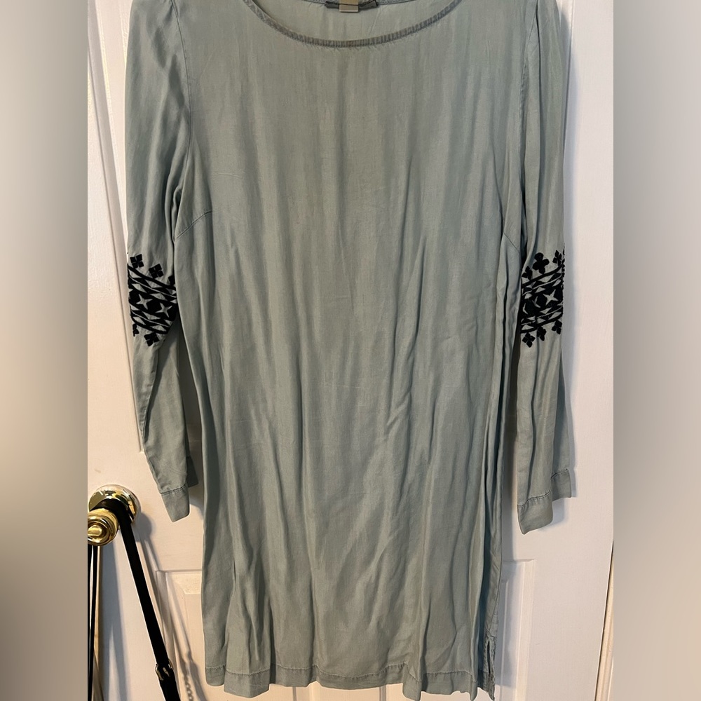 Selling a blue Jean colored dress with black embroidery on each sleeve.